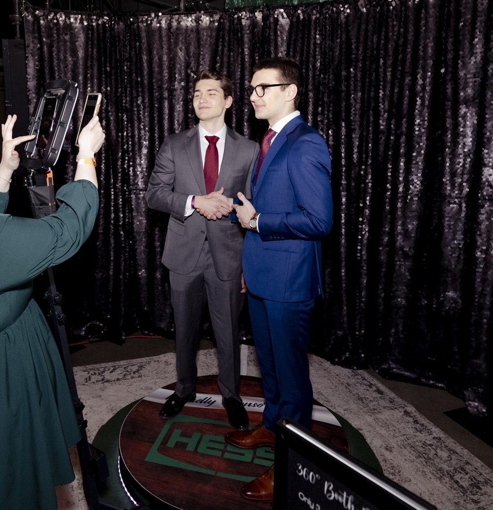 Couple sharing a kiss beside the KZ PhotoBooth at a gala event